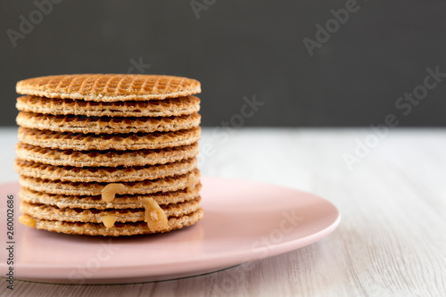 Wallpaper Mural Stack of sweet Dutch stroopwafels with honey-caramel filling on pink plate, side view. Copy space. Torontodigital.ca