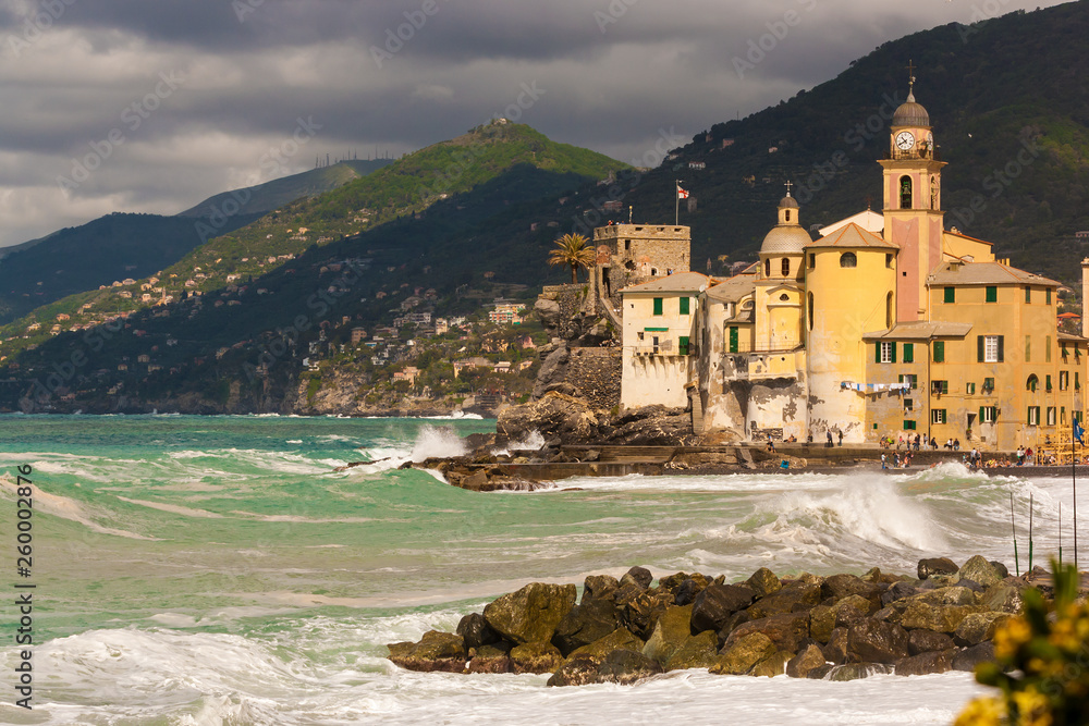 View of Camogli with its stormy sea in the Ligurian Riviera in Italy.