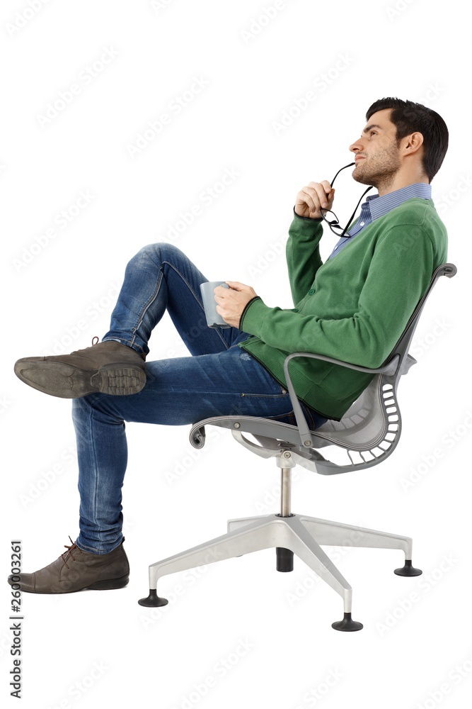 Side view of daydreaming man sitting in chair