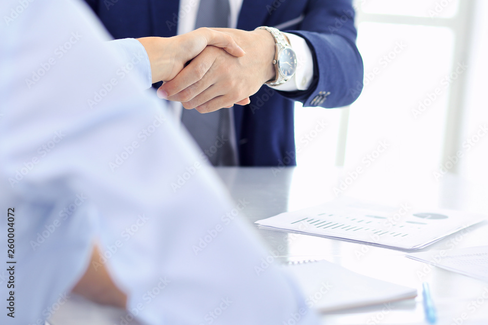 Group of business people or lawyers shaking hands finishing up a meeting , close-up. Success at negotiation and handshake concepts Group of business people or lawyers shaking hands finishing up a meeting , close-up. Success at negotiation and handshake concepts
