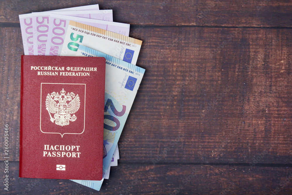 Obraz premium A passport with euro banknotes inside as work and travelling concept