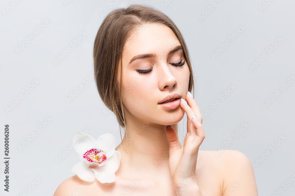 Natural blonde girl with health skin and with orchid on back posing on photo! Natural blonde girl with health skin and with orchid on back posing on photo!