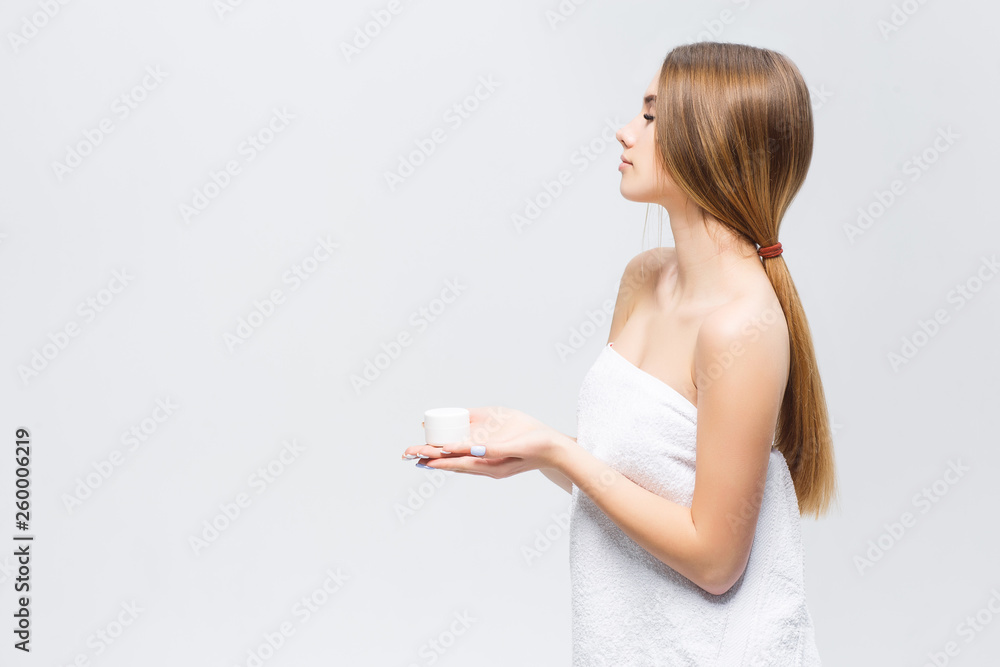 Beauty skin care. Happy woman applying cosmetic cream on clean Face. Closeup portrait of healthy model with natural makeup. Beauty skin care. Happy woman applying cosmetic cream on clean Face. Closeup portrait of healthy model with natural makeup.