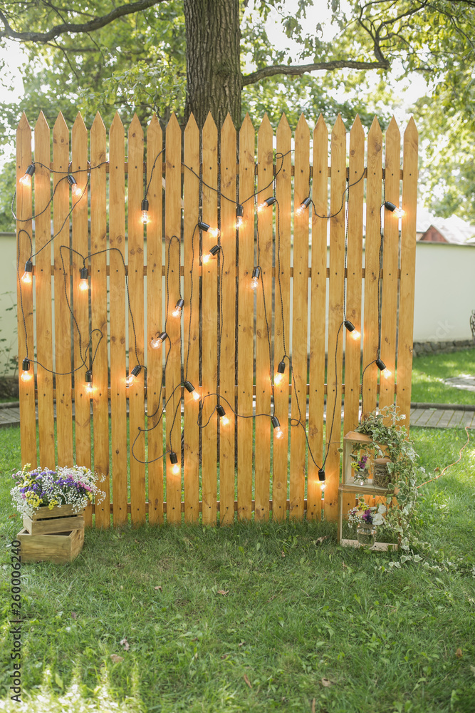 Fototapeta premium Wooden photozone with a lamp for a party and a photo shoot