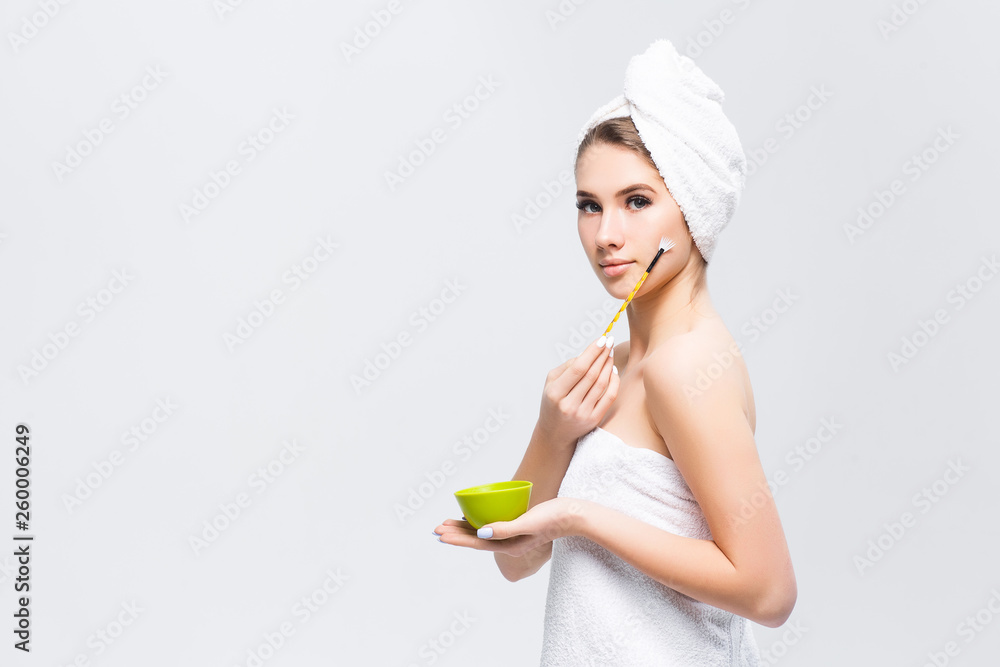 Beautiful woman with makeup brush isolated on white. Blonde girl applying blush on her cheek . Beautiful woman with makeup brush isolated on white. Blonde girl applying blush on her cheek .