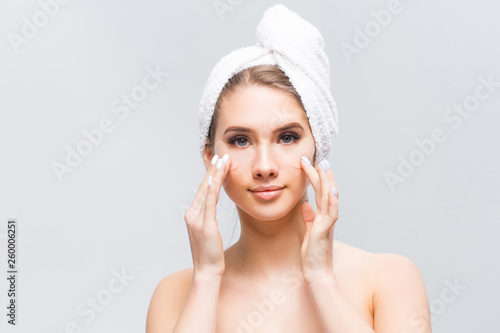 Young female model with natural facial makeup and patches product on face on White background. High Resolution.