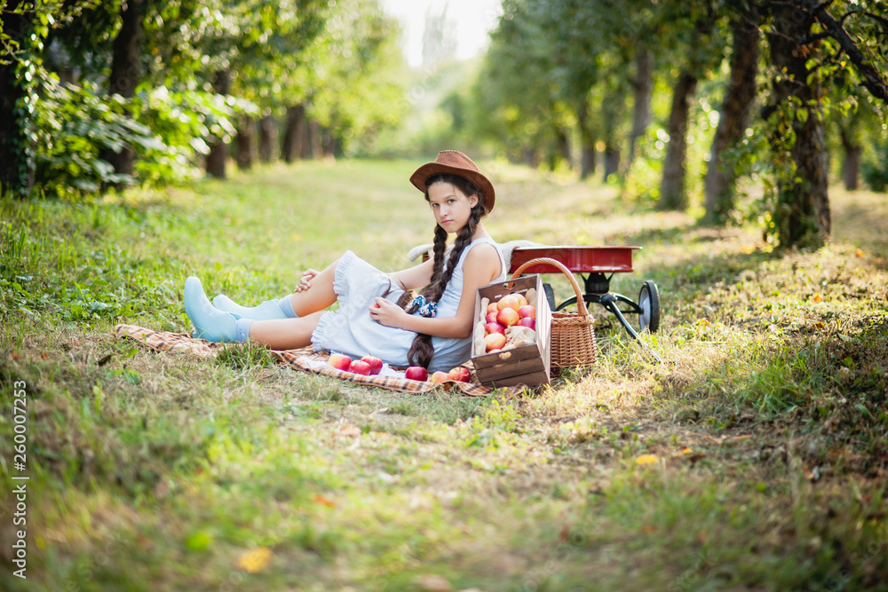 Fototapeta premium Girl with Apple in the Apple Orchard