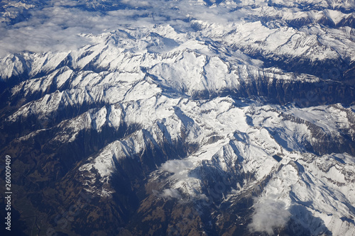 Alps mountains in spring. Aerial view from air plane