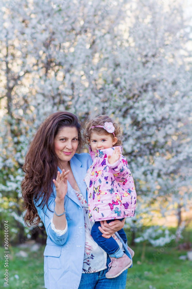 Happy Mother with her Kid in the Spring Park .Mother and Daughter .Happy Family.Mother with Little Child Happy Mother with her Kid in the Spring Park .Mother and Daughter .Happy Family.Mother with Little Child