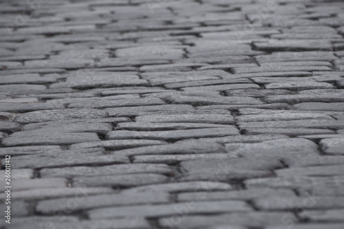 Ancient stone pavement background. The texture of old cobblestone paving.