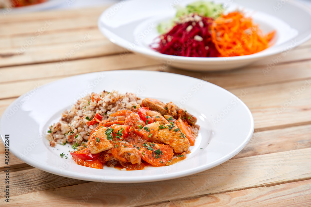 meat with buckwheat and salad on the wooden background meat with buckwheat and salad on the wooden background