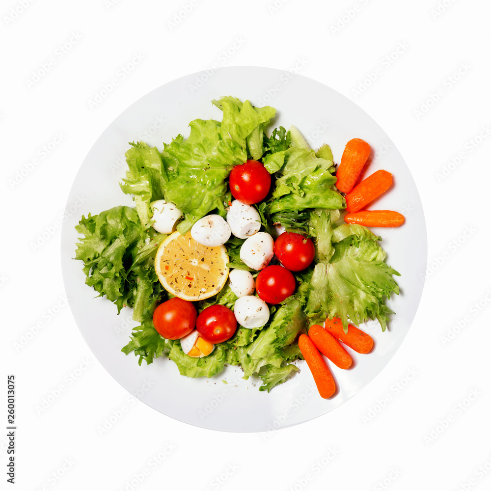 Healthy food. Tasty salad with cherry tomatoes, salad leaves, lemon, spices, carrot and quail eggs isolated on white background. Healthy food. Tasty salad with cherry tomatoes, salad leaves, lemon, spices, carrot and quail eggs isolated on white background.