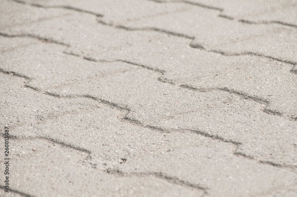 Street pavement cement slabs surface closeup as background Street pavement cement slabs surface closeup as background