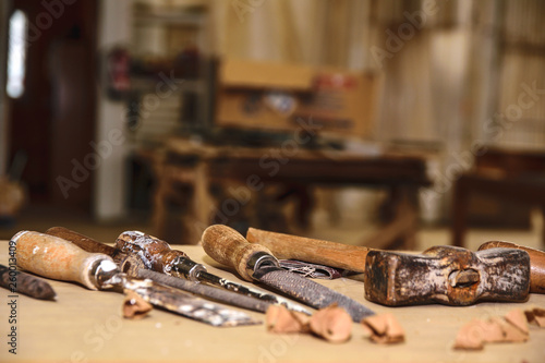 Carpenter tools. Chisel or gouge for wood on carpenter working at workbench. Carpentry workshop photo