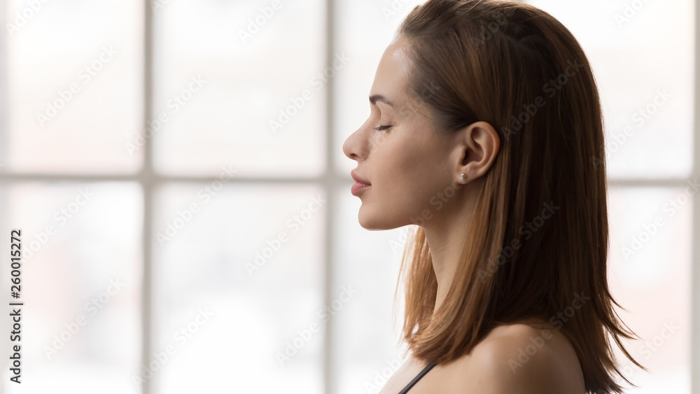 Portrait of beautiful woman with closed eyes, practicing yoga, meditation Portrait of beautiful woman with closed eyes, practicing yoga, meditation