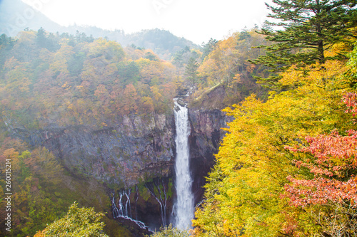 Japanese waterfall in autumn season with colorful tree leaves photo
