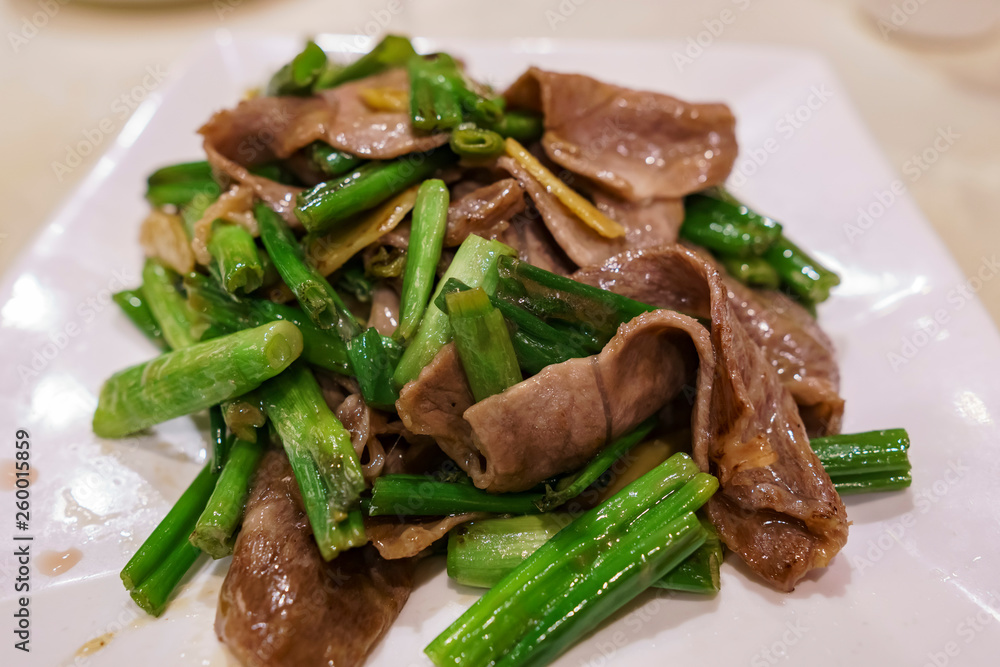 Close up shot of fried beef with green onions
