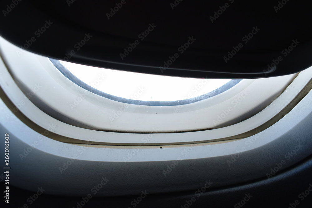 close up of plane window frame height in sky close up of plane window frame height in sky