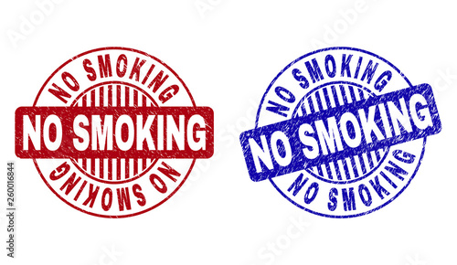 Grunge NO SMOKING round stamp seals isolated on a white background. Round seals with grunge texture in red and blue colors. Vector rubber watermark of NO SMOKING label inside circle form with stripes.