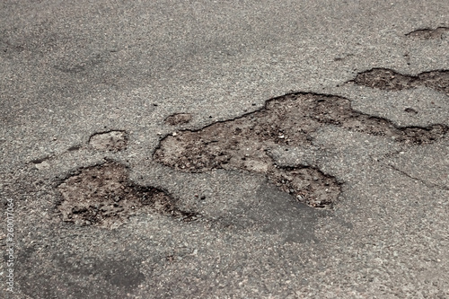 The road in disrepair with a lot of potholes. Cars go with the risk of breakdowns. © Aliaksandr Marko