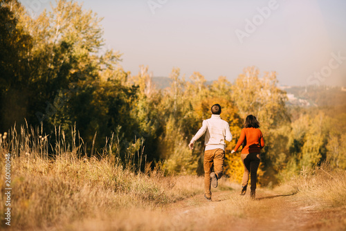 loving couple is running in the field