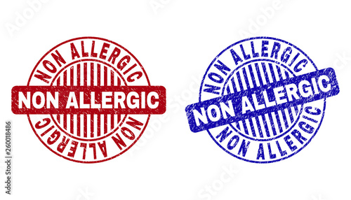 Grunge NON ALLERGIC round stamp seals isolated on a white background. Round seals with grunge texture in red and blue colors. Vector rubber overlay of NON ALLERGIC tag inside circle form with stripes.