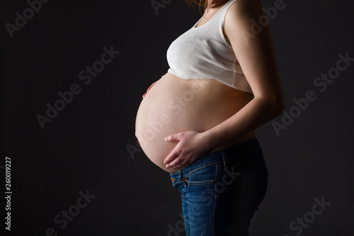 pregnant woman, expectant mother on black background,