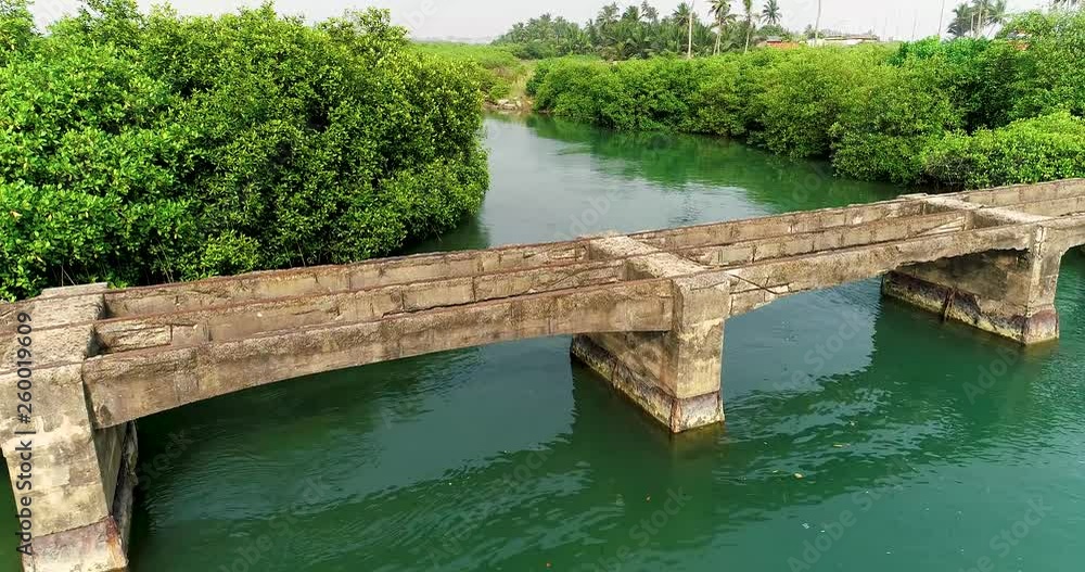 A 4k aerial shot of an ancient bridge on a river. A 4k aerial shot of an ancient bridge on a river.