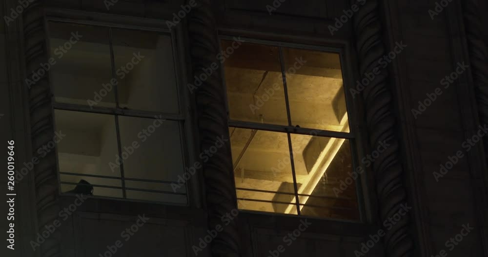The side of a building looking in the windows at night, close up The side of a building looking in the windows at night, close up