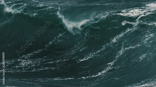 Large foamy wave barrelling onto a shallow reef. Slow motion. photo