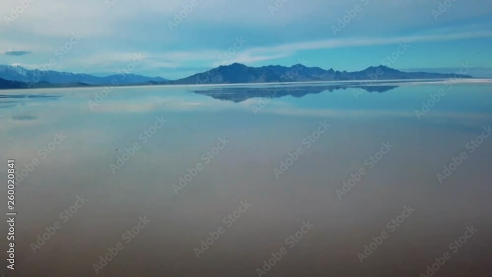 Bonneville Salt Flats located in Utah during Spring where a shallow layer or water creates a beautiful mirage of the sky and mountains in the background. Bonneville Salt Flats located in Utah during Spring where a shallow layer or water creates a beautiful mirage of the sky and mountains in the background.