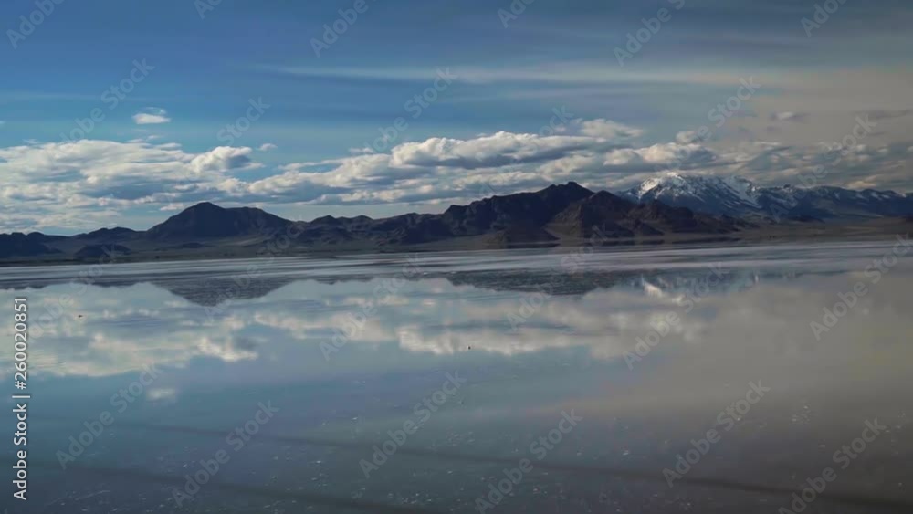 Bonneville Salt Flats located in Utah during Spring where a shallow layer or water creates a beautiful mirage of the sky and mountains in the background. Bonneville Salt Flats located in Utah during Spring where a shallow layer or water creates a beautiful mirage of the sky and mountains in the background.