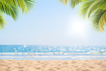 Abstract seascape with palm tree, tropical beach background. blur bokeh light of calm sea and sky. summer vacation background concept.