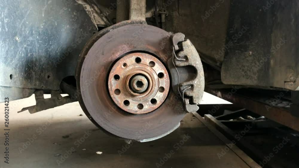 Rusty car brake disc with suspension components. Rusty car brake disc with suspension components.
