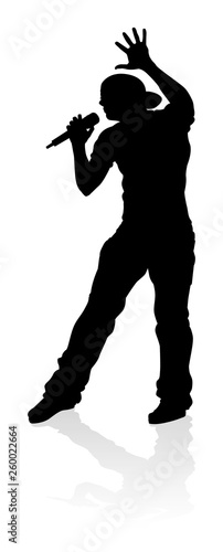 A singer pop, country music, rock star or hiphop rapper artist vocalist singing in silhouette