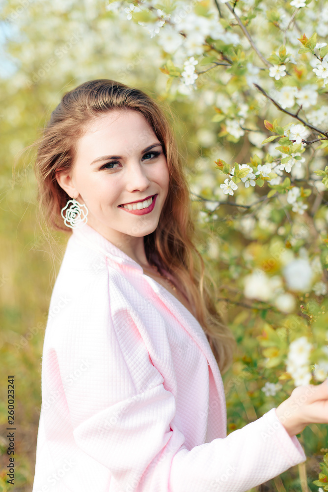 beautiful blonde girl outdoors in spring near blooming gardens 1 beautiful blonde girl outdoors in spring near blooming gardens 1