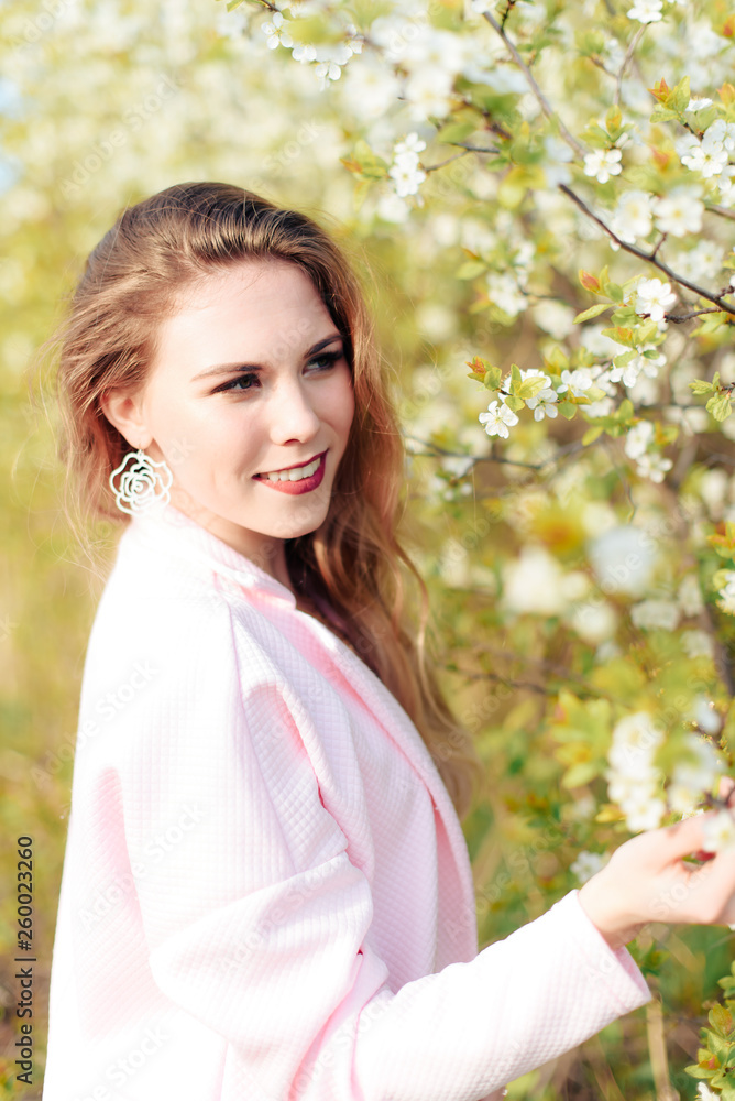 beautiful blonde girl outdoors in spring near blooming gardens 1 beautiful blonde girl outdoors in spring near blooming gardens 1