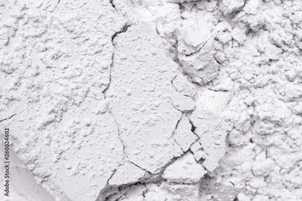 White cosmetic clay powder textured background, close up