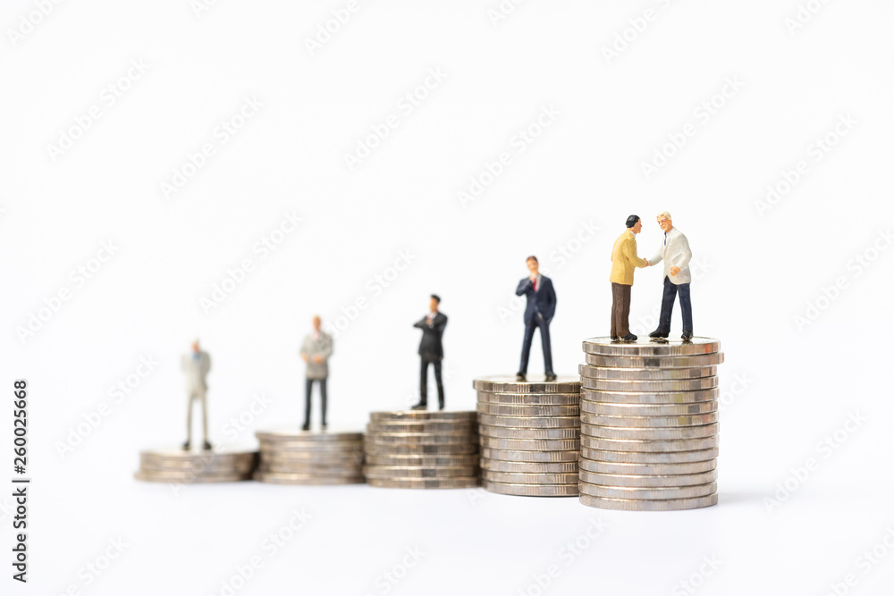 Miniature people, business man standing on stack of coins. Invesment, financial, and savings concept. Miniature people, business man standing on stack of coins. Invesment, financial, and savings concept.