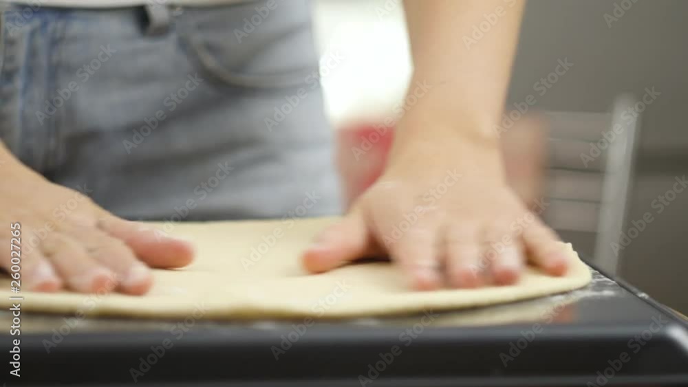 Cooking pizza. The chef prepares the pizza dough. A man or woman is engaged in home business preparing a delicious pizza Cooking pizza. The chef prepares the pizza dough. A man or woman is engaged in home business preparing a delicious pizza