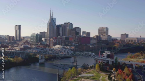 Nashville city, aerial pan with John Seigenthaler Pedestrian Bridge and city skyline on beautiful morning sunrise photo