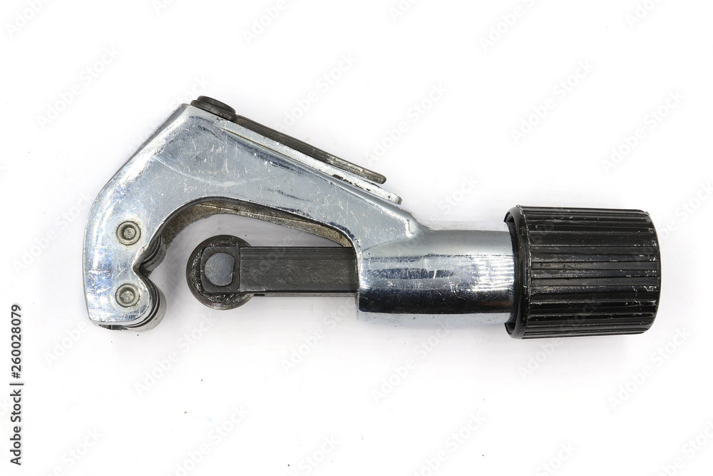 Metal pipe cutter, Industrial Plumber cutting a copper pipe, pipe cutter isolated on white background Metal pipe cutter, Industrial Plumber cutting a copper pipe, pipe cutter isolated on white background