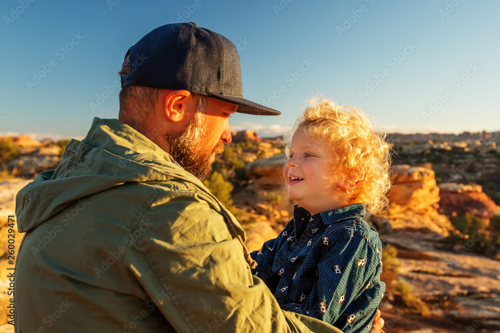 Hiker with boy in Canyonlands National park, needles in the sky, in Utah, USA Hiker with boy in Canyonlands National park, needles in the sky, in Utah, USA