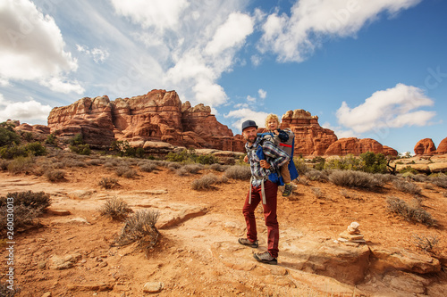 Hiker with boy in Canyonlands National park, needles in the sky, in Utah, USA © Maygutyak