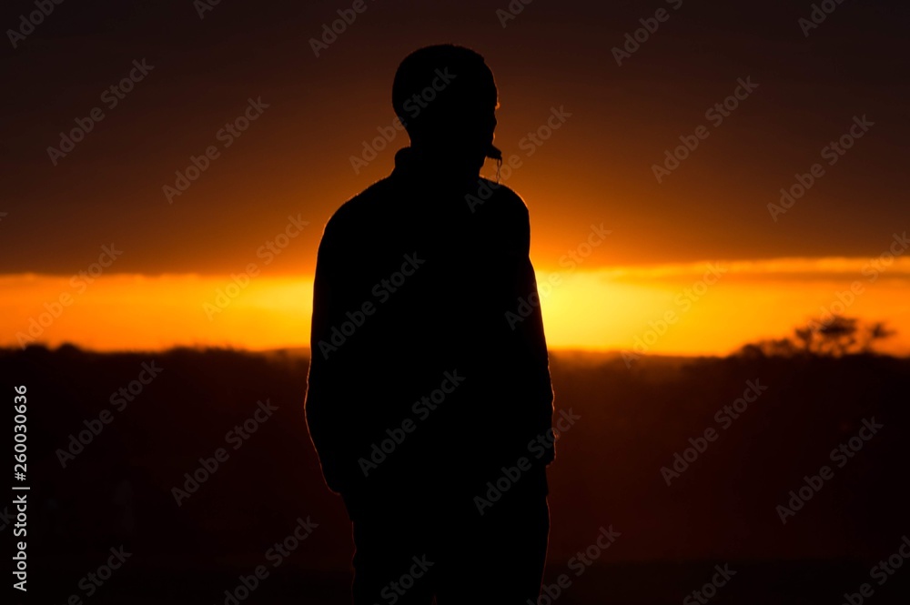 silhouette of man at sunset