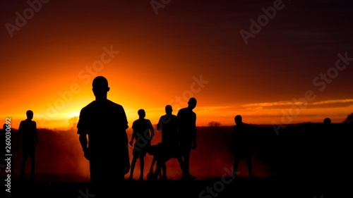 silhouettes of people at sunset