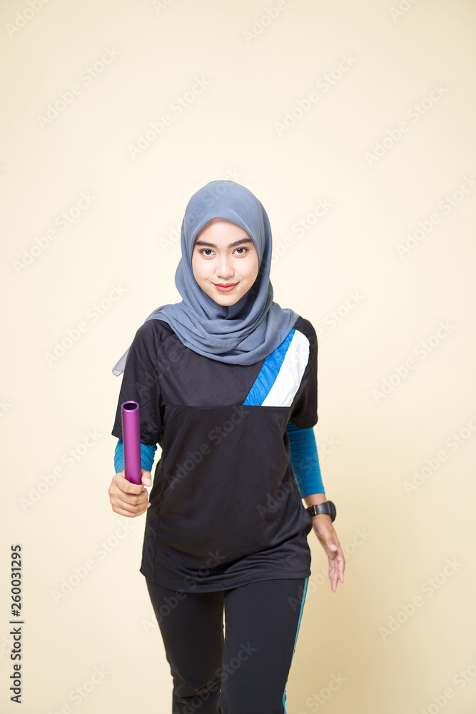 Sport Girl in Black/Blue Shirt Running with Baton Sport Girl in Black/Blue Shirt Running with Baton