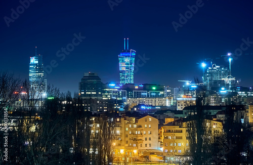 Beautiful  amazing panoramic view of Warsaw  Poland  with skyscrapers and a Palace of Culture and Science during spring flowering at night