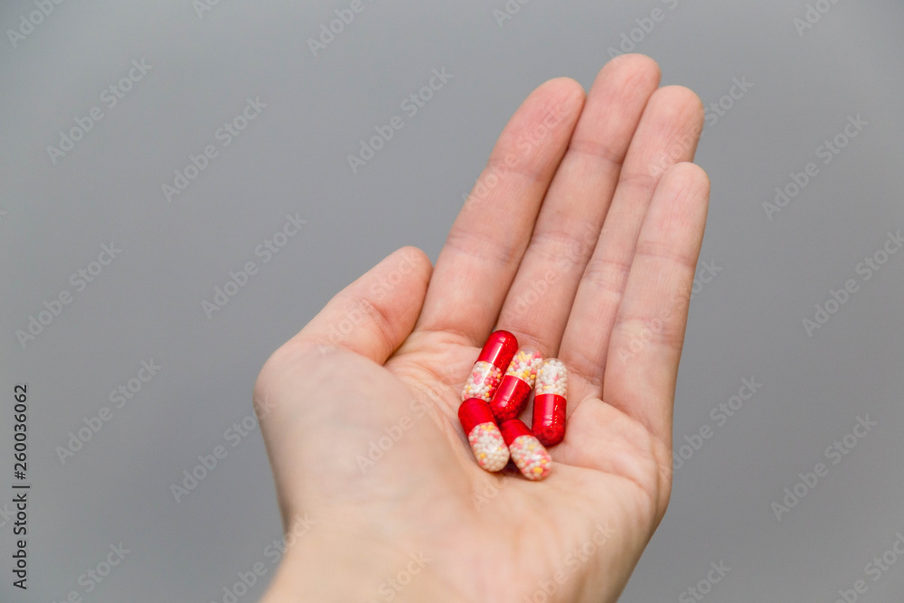 Tablets and pills on the palm of a person. An elderly man holds a lot of colored pills in old hands. Painful old age. Health care of older people. Top View Tablets and pills on the palm of a person. An elderly man holds a lot of colored pills in old hands. Painful old age. Health care of older people. Top View