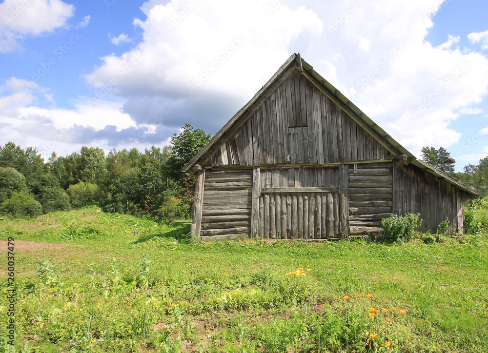 Summer landscape in the countryside in Latvia, East Europe. Old wooden shed. Summer landscape in the countryside in Latvia, East Europe. Old wooden shed.